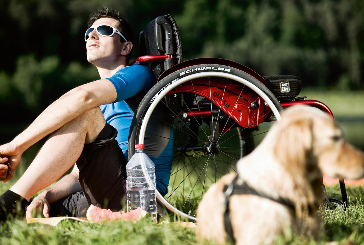 Motus - Quickie Argon 2 manual wheelchair in Red on grass
